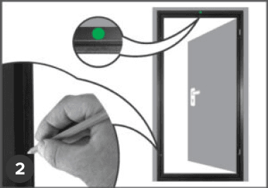 A hand marks a spot on a door frame with a pencil during swing door installation; the open door and mark are shown in close-up.